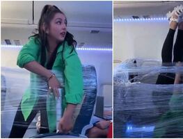 Video. Mujer envuelve asientos con plástico para aislarse en un avión