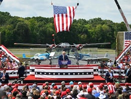 Trump aparece detrás de cristal antibalas en su primer evento al aire libre desde atentado