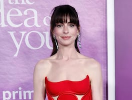 Anne Hathaway arrasa Nueva York con impresionante vestido rojo strapless de Versace